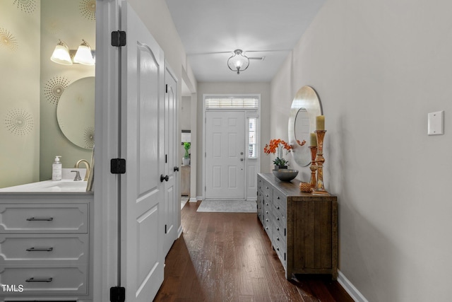 foyer featuring sink and dark hardwood / wood-style floors