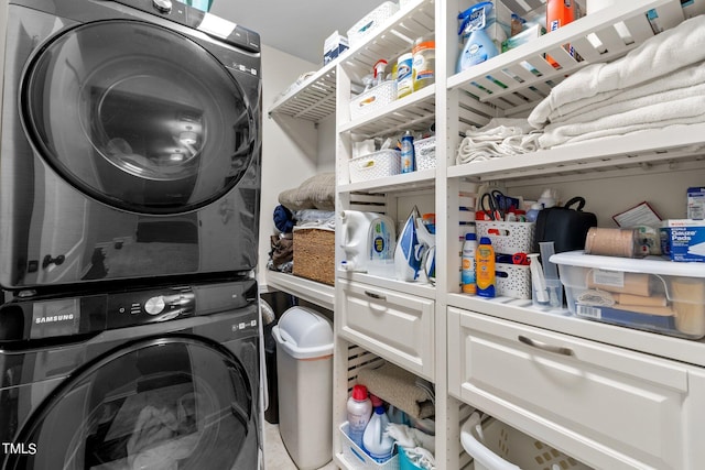 laundry area featuring tile patterned flooring and stacked washer and dryer