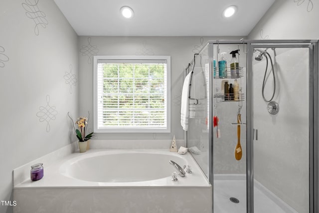 bathroom featuring separate shower and tub