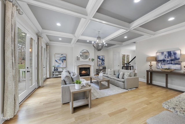 living room featuring an inviting chandelier, light hardwood / wood-style floors, coffered ceiling, and beamed ceiling