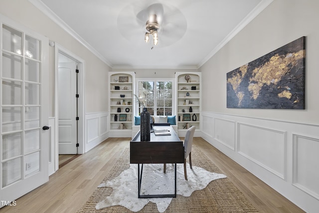 home office with light hardwood / wood-style floors, built in features, crown molding, and ceiling fan