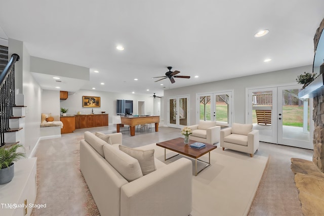 carpeted living room with ceiling fan, french doors, and billiards