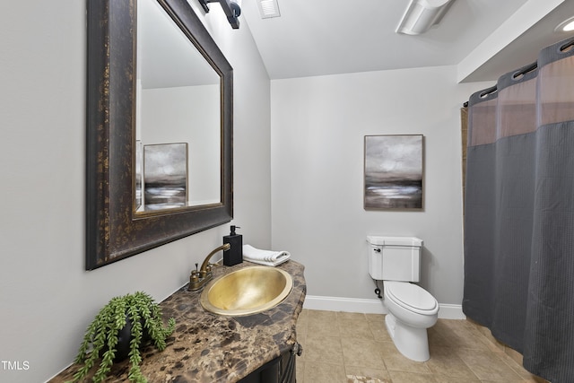 bathroom featuring toilet, tile patterned flooring, and vanity