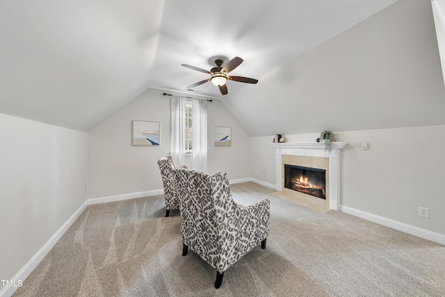 living area featuring ceiling fan, vaulted ceiling, and carpet floors