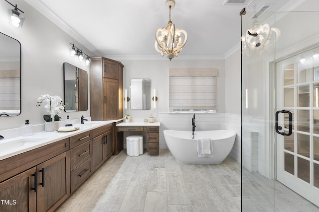 bathroom featuring wood-type flooring, vanity, a bathtub, ornamental molding, and a notable chandelier