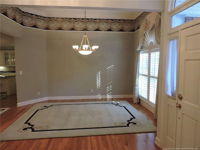 interior space featuring hardwood / wood-style floors and a notable chandelier