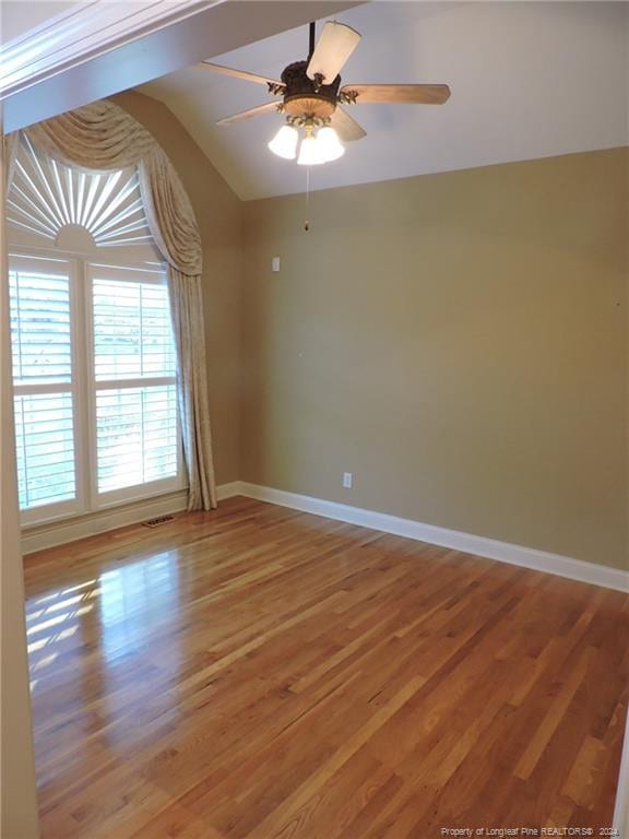 empty room featuring hardwood / wood-style floors, ceiling fan, and lofted ceiling