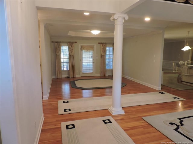 exercise area with wood-type flooring and ornate columns