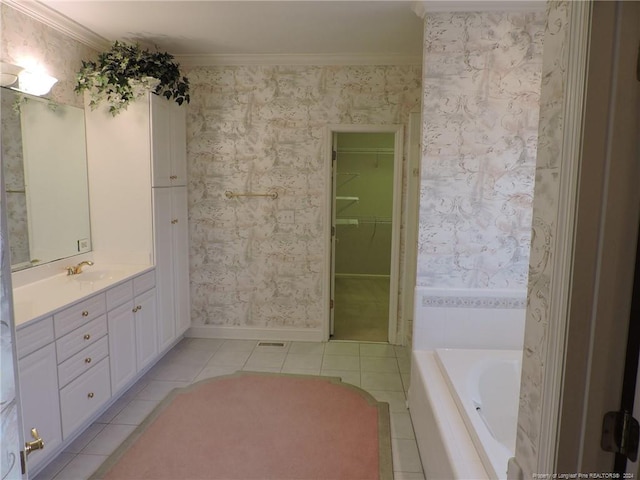 bathroom featuring a bathing tub, vanity, tile patterned floors, and crown molding