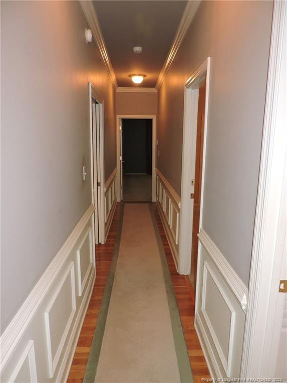 hall featuring hardwood / wood-style flooring and ornamental molding