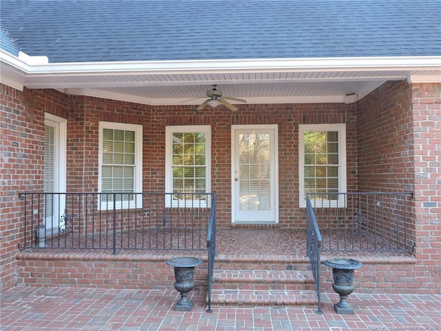 entrance to property featuring ceiling fan and covered porch