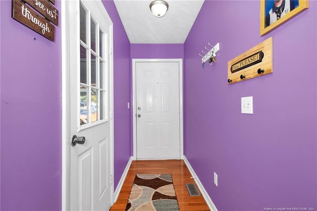 entryway with hardwood / wood-style flooring