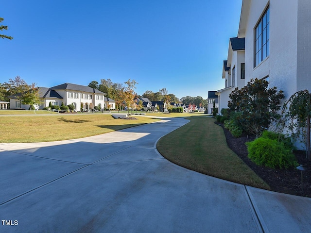 view of home's community featuring a lawn