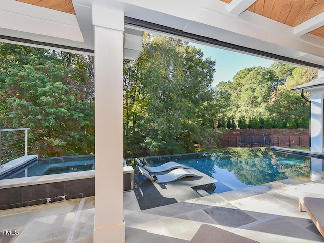 view of swimming pool with an in ground hot tub and a patio