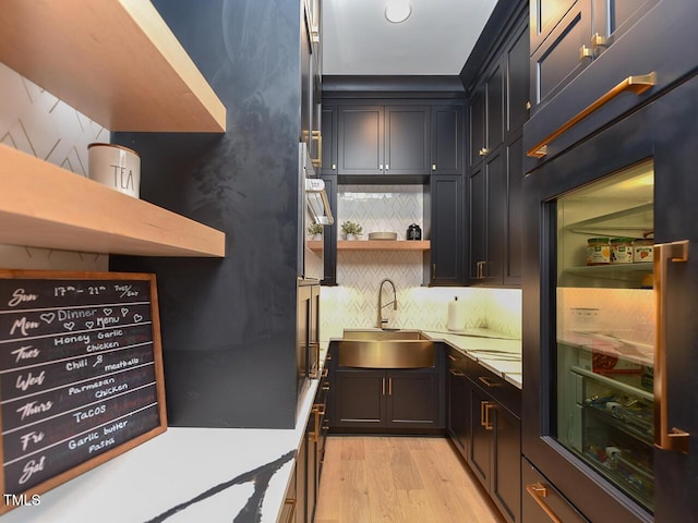 kitchen featuring light hardwood / wood-style flooring, sink, and fridge