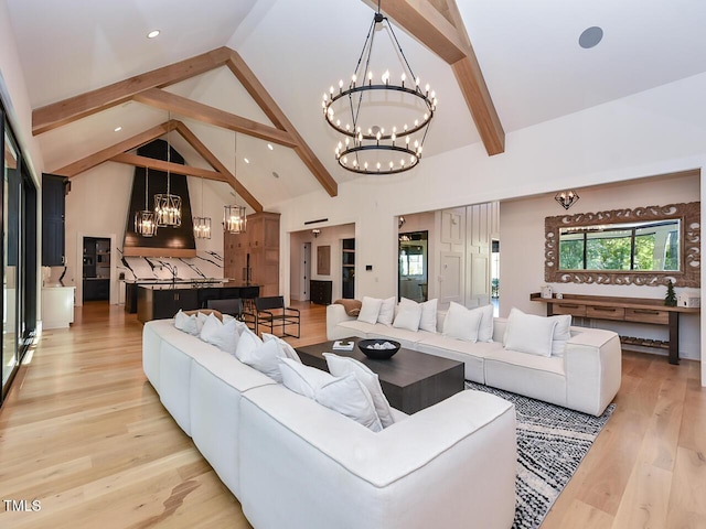 living room featuring an inviting chandelier, beamed ceiling, light hardwood / wood-style floors, and high vaulted ceiling