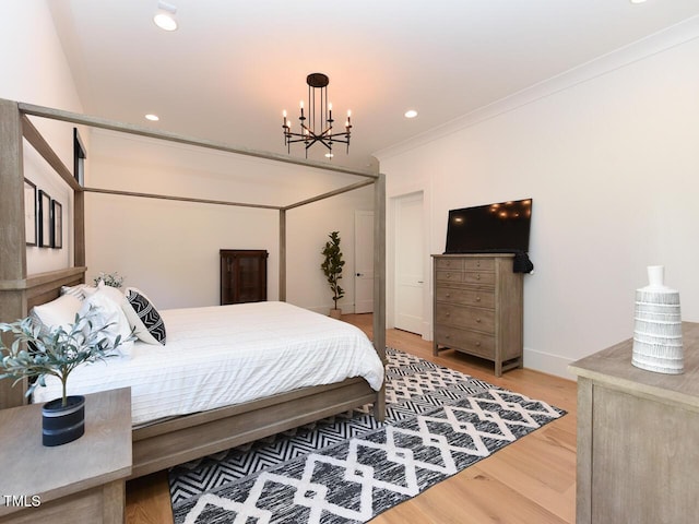 bedroom featuring wood-type flooring, crown molding, and a notable chandelier