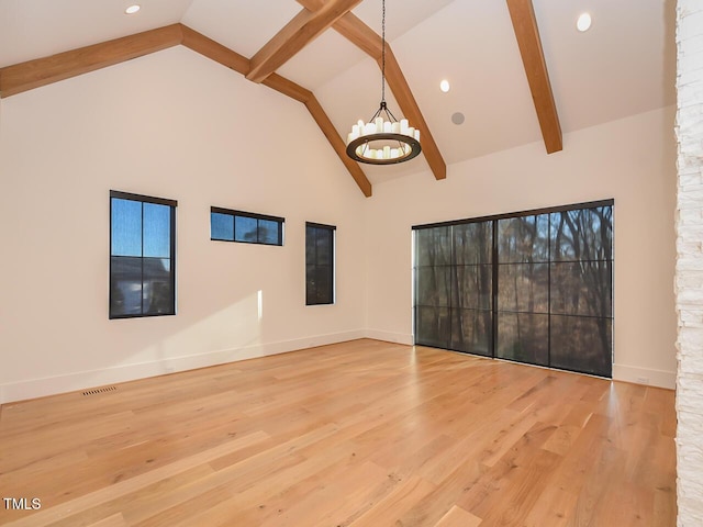 unfurnished living room featuring beam ceiling, wood-type flooring, high vaulted ceiling, and an inviting chandelier