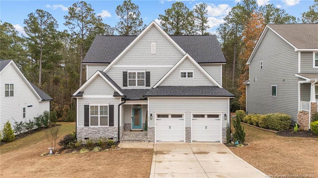 craftsman-style home with a garage and a front yard