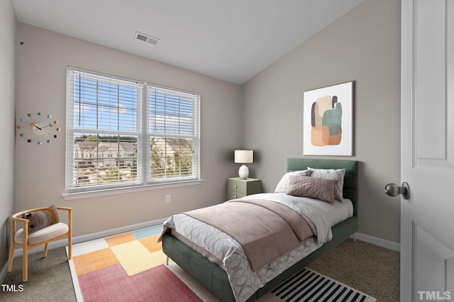 carpeted bedroom featuring lofted ceiling