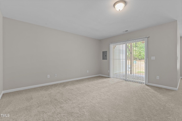 carpeted empty room featuring electric panel