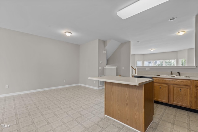 kitchen with a kitchen breakfast bar, a kitchen island, and sink