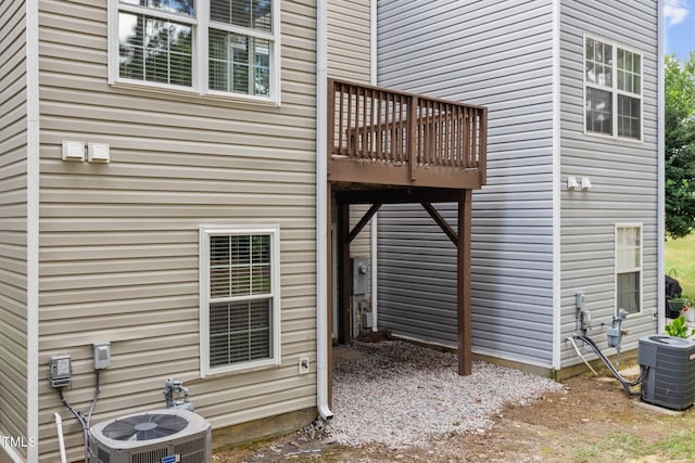 view of side of property featuring a deck and cooling unit