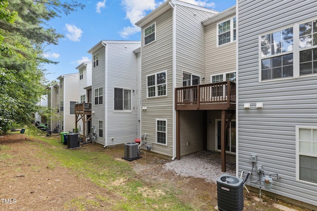 rear view of house featuring central AC unit