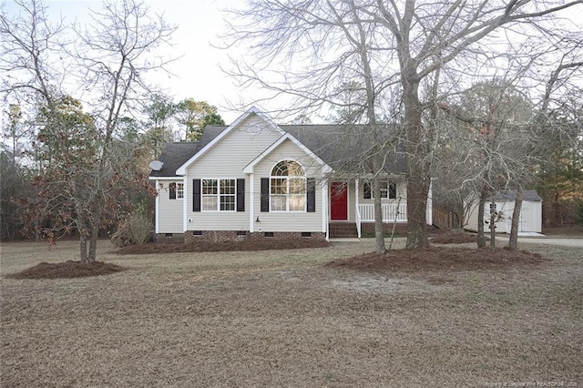 ranch-style home with a garage and a storage shed