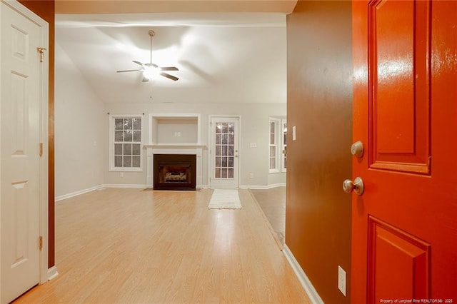 unfurnished living room featuring ceiling fan and light wood-type flooring