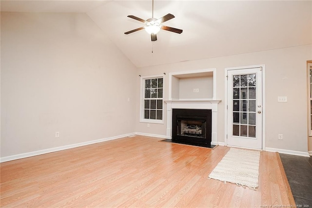 unfurnished living room featuring ceiling fan, wood-type flooring, and lofted ceiling