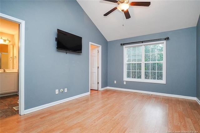 unfurnished bedroom with ceiling fan, lofted ceiling, ensuite bathroom, and light hardwood / wood-style floors