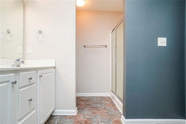 bathroom featuring walk in shower and vanity