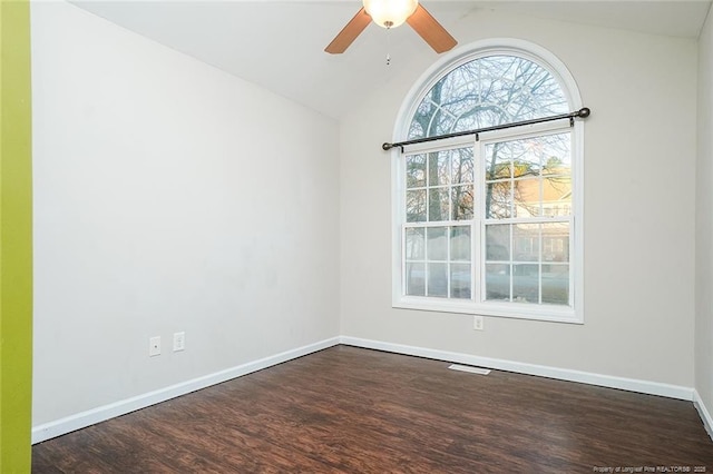 unfurnished room with ceiling fan, lofted ceiling, and dark hardwood / wood-style flooring