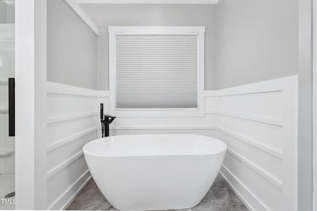 bathroom with tile patterned flooring and a bathtub