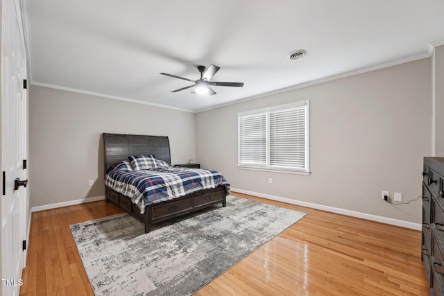 bedroom with ceiling fan, crown molding, and light hardwood / wood-style flooring