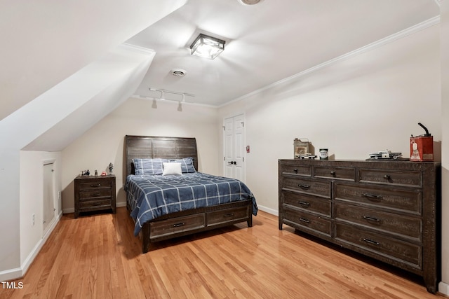 bedroom featuring light hardwood / wood-style flooring and ornamental molding