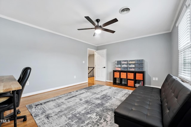 office area with ceiling fan, wood-type flooring, and ornamental molding