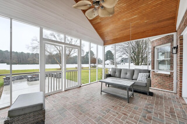 sunroom featuring a water view, plenty of natural light, and ceiling fan