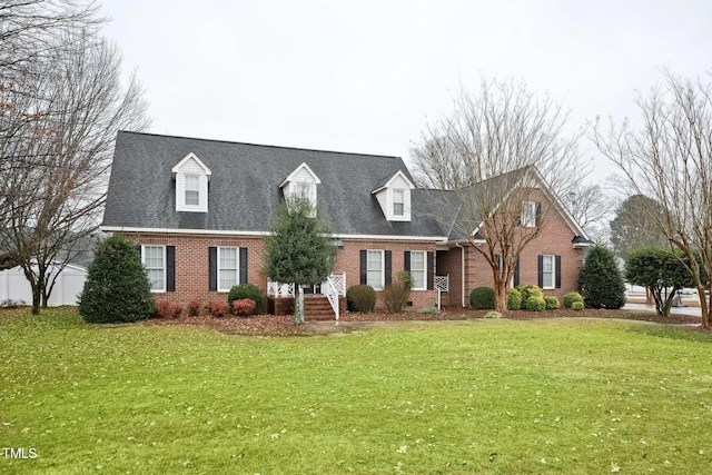 cape cod home with a front yard