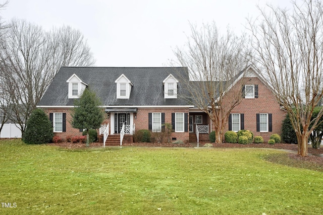 cape cod house with a front lawn