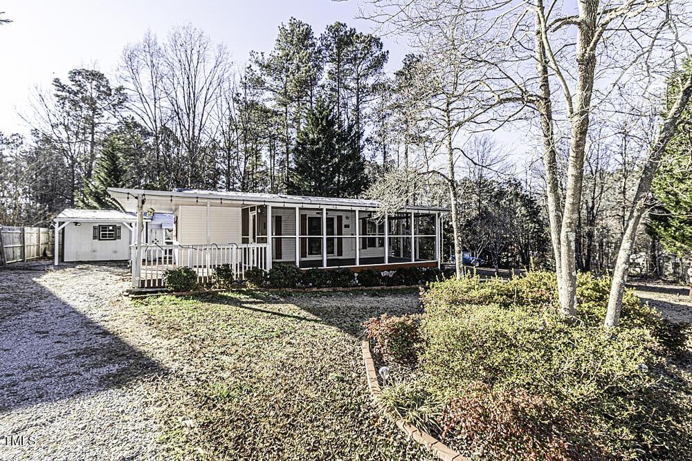 rear view of property featuring a sunroom