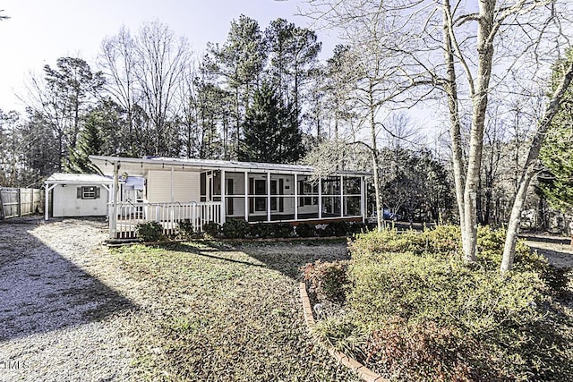 rear view of property featuring a sunroom