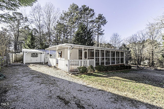 view of front of home with a storage shed