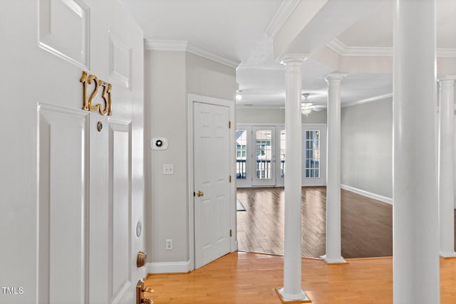 foyer with ornate columns, ceiling fan, light hardwood / wood-style floors, and ornamental molding