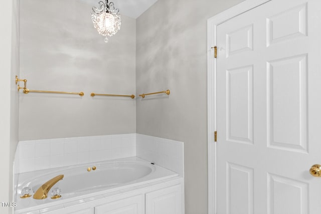 bathroom featuring a tub to relax in and a chandelier