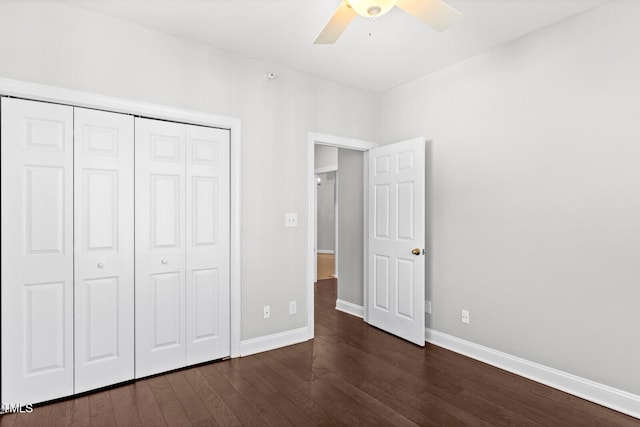 unfurnished bedroom with ceiling fan, a closet, and dark hardwood / wood-style floors