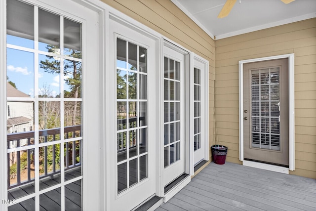 exterior space featuring hardwood / wood-style flooring, ceiling fan, a healthy amount of sunlight, and wooden walls