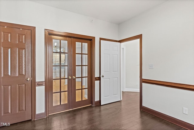 empty room with french doors and dark hardwood / wood-style flooring