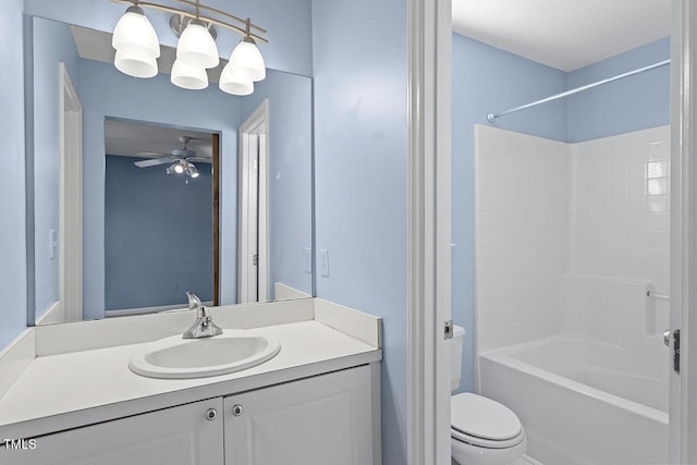 full bathroom featuring ceiling fan, washtub / shower combination, a textured ceiling, toilet, and vanity